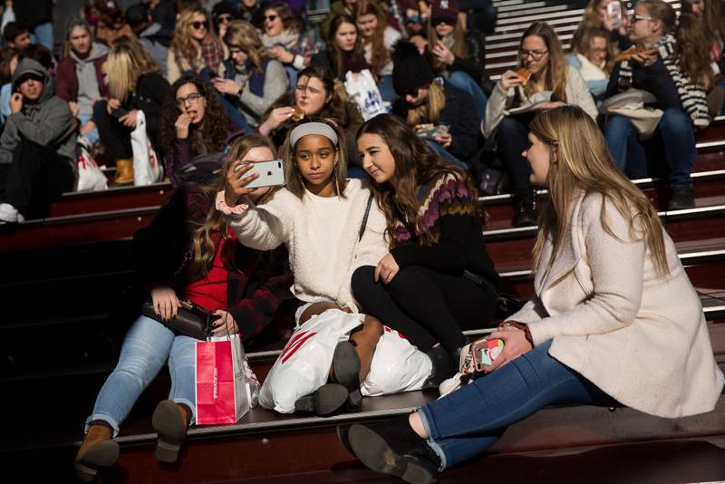 NEW YORK, NY - DECEMBER 01: A group of teens take a photograph with a smartphone in Times Square, December 1, 2017 in New York City.  The photo-sharing app Instagram has released data for its most-Instagrammed cities and locations for 2017. New York City is ranked number one, with Moscow and London coming in second and third. Among the most photographed locations in New York City were the Brooklyn Bridge, Times Square and Central Park.