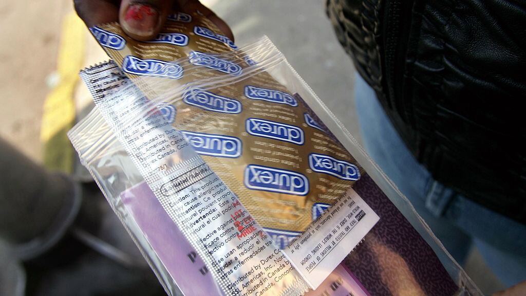 CAMDEN, NJ - FEBRUARY 17: A woman holds a packet of condoms and a sexual transmitted disease (STD) informational packet she received February 17, 2005 from a mobile health van from the Camden Area Health Education Center in Camden, New Jersey. Camden, a crime-ridden city in the south of New Jersey, has both a high prostitution rate and an escalating HIV/AIDS rate among its young people. A New York man infected with a highly drug-resistant and possibly aggressive strain of the AIDS virus has galvanized health officials around the country to consider the possibility of what some people are calling a "Super HIV strain."