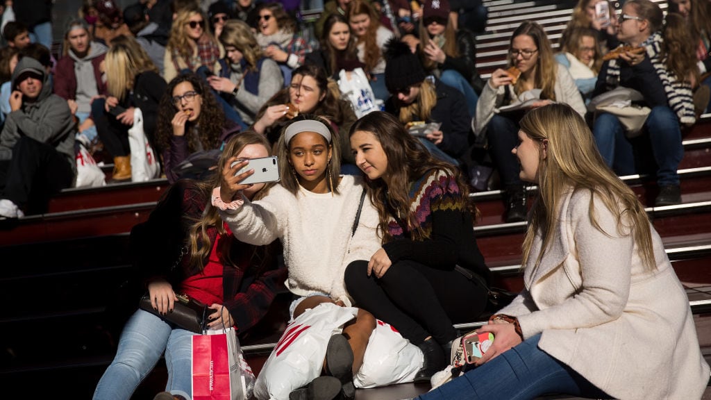 NEW YORK, NY - DECEMBER 01: A group of teens take a photograph with a smartphone in Times Square, December 1, 2017 in New York City. The photo-sharing app Instagram has released data for its most-Instagrammed cities and locations for 2017. New York City is ranked number one, with Moscow and London coming in second and third. Among the most photographed locations in New York City were the Brooklyn Bridge, Times Square and Central Park.