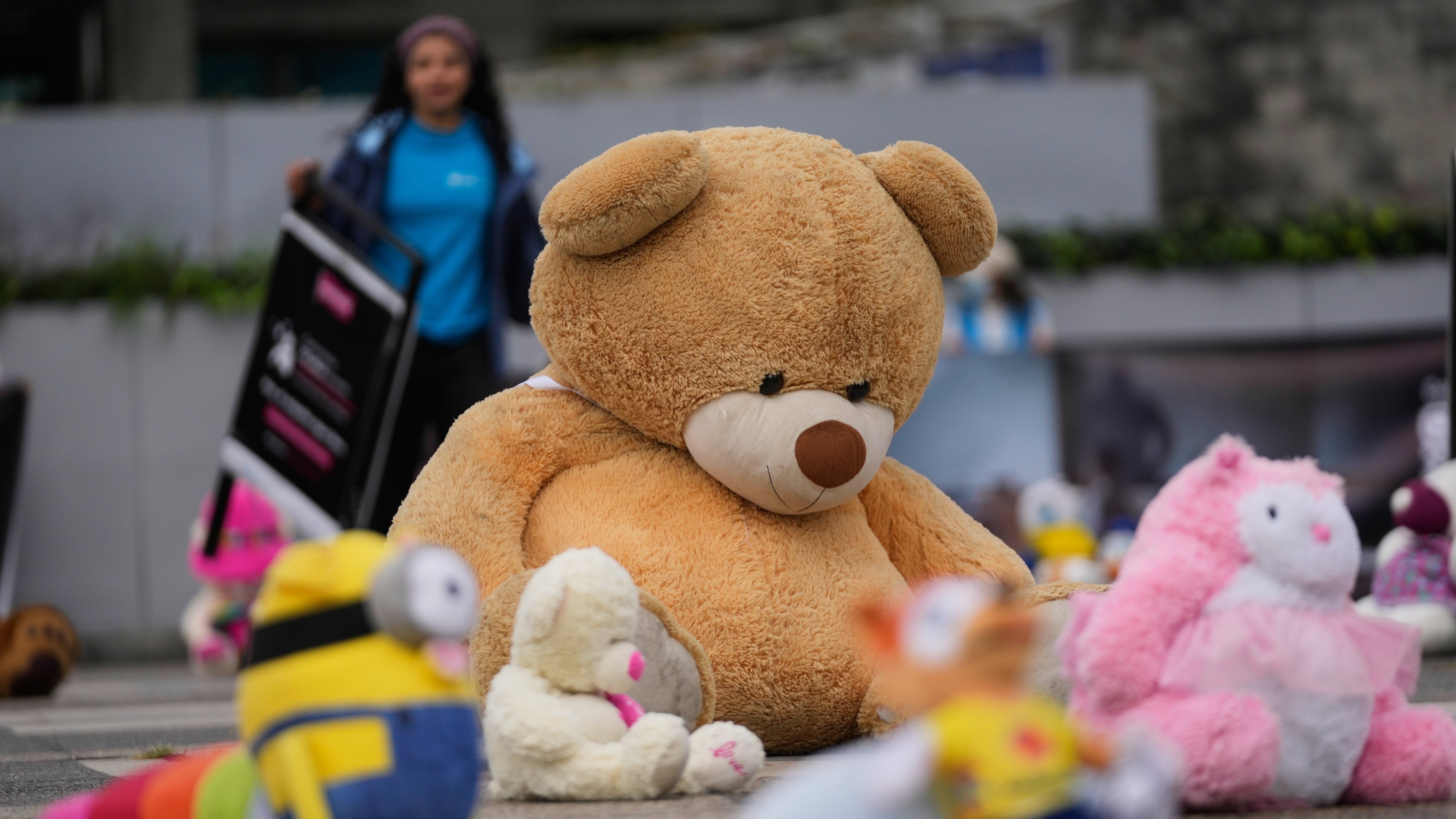 Juguetes se exhiben frente a la Fiscalía en un acto simbólico que busca llamar la atención sobre el abuso sexual infantil en Bogotá, Colombia, el jueves 20 de noviembre de 2025. (AP Foto/Fernando Vergara)