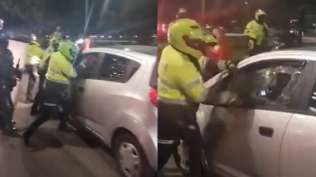 Momento en que la Policía parte vidrio de un carro a conductor en Bogotá.