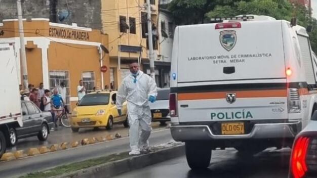 Funcionarios de Medicina Legal hacen el levantamiento del cadáver.